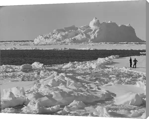 Iceberg in pack ice. Tryggve Gran and Thomas McLeod on ice. December 20th 1910