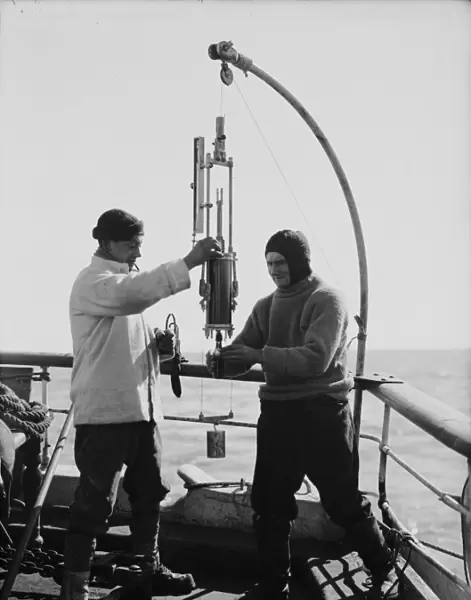 Edward Nelson and Dennis Lillie taking sample from bottle. January 1st 1911