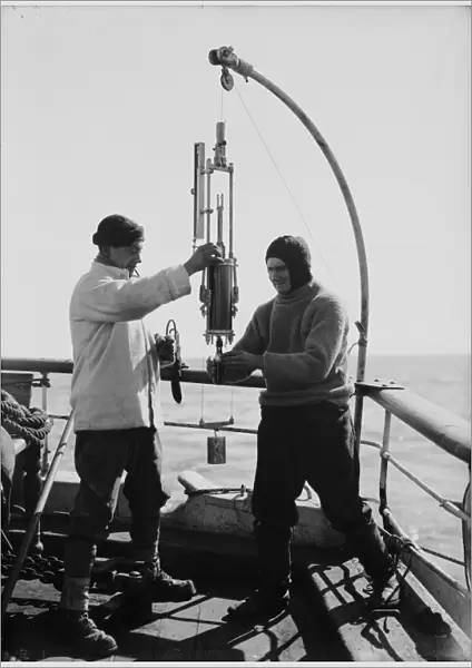 Edward Nelson and Dennis Lillie taking sample from bottle. January 1st 1911