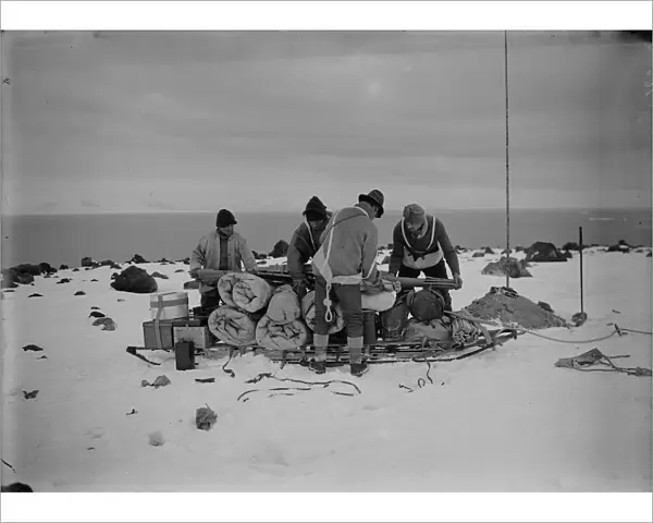 Packing a sledge at top of moraine for trip to Shackletons hut. February 11th 1911