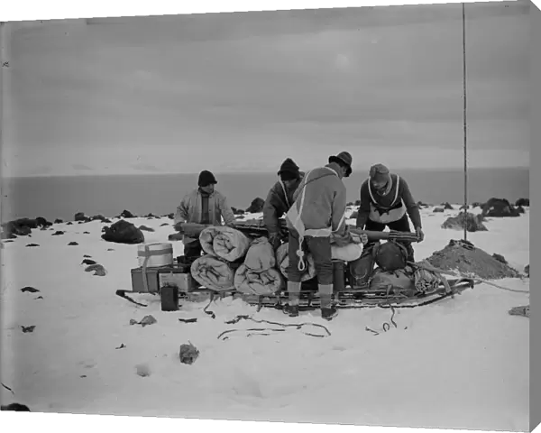 Packing a sledge at top of moraine for trip to Shackletons hut. February 11th 1911