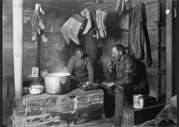 Cecil Meares and Dimitri Geroff at the blubber stove in the Discovery Hut at Hut Point. November 3rd 1911