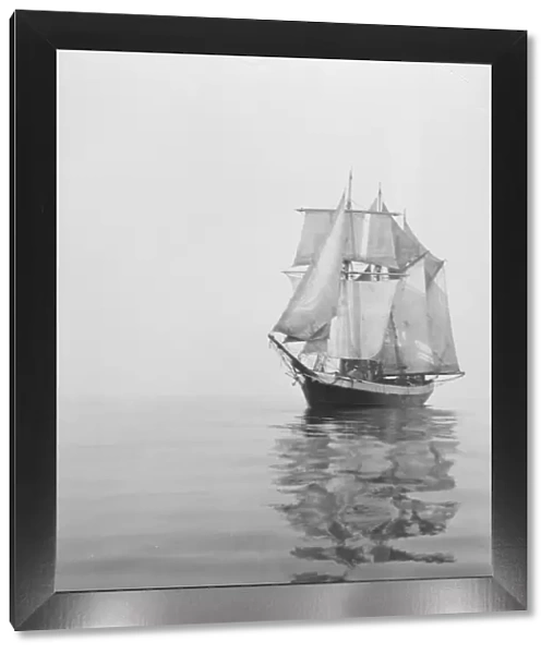 Penola at sea with sails set, reflections in the water