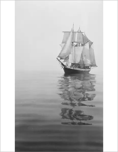 Penola at sea with sails set, reflections in the water