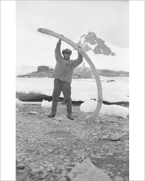 Bagshawe near base hut, holding whale bone, Waterboat Point, Paradise Bay