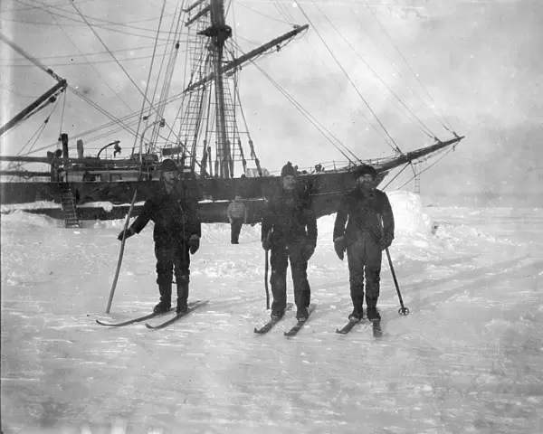 Three mates on skis, winter quarters. Second steward in background