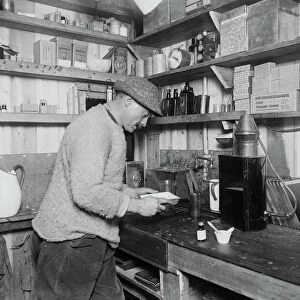 Herbert Ponting at work in darkroom. March 24th 1911