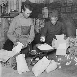 At Winterquarters Hut, packing sugar for sledging rations. January 1912