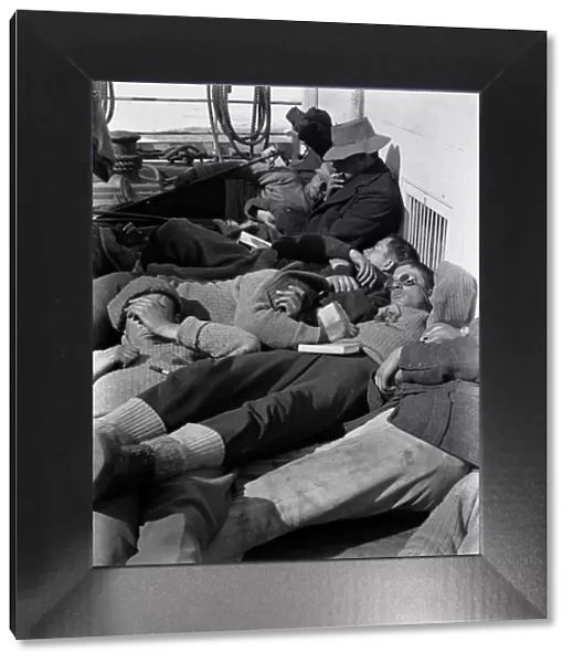A warm day in the pack. Expedition members lie in the sun on the deck of the ship Terra Nova. December 28th 1910