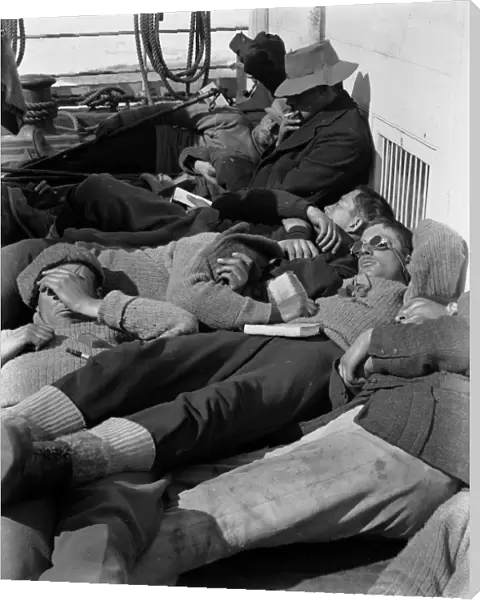 A warm day in the pack. Expedition members lie in the sun on the deck of the ship Terra Nova. December 28th 1910