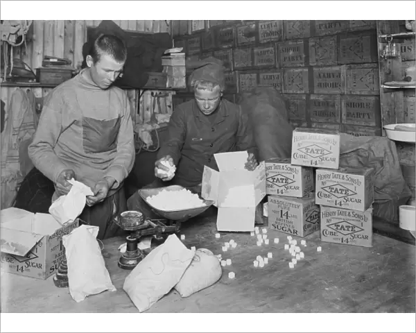At Winterquarters Hut, packing sugar for sledging rations. January 1912