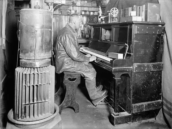 Cecil Meares at the pianola in the Winterquarters Hut. January 1912