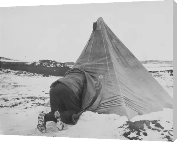 Dr Edward Wilson entering his tent at Cape Royds