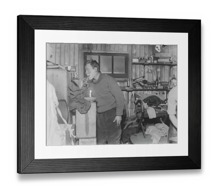 Framed Print : George Murray Levick shaves by candlelight in the hut
