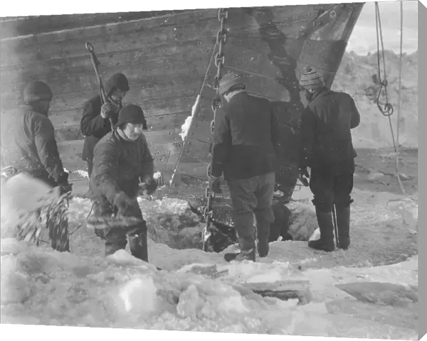 Trying to cut the anchor free from the ice