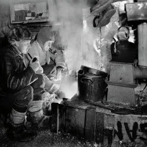 Cecil Meares and Capt Oates at the blubber stove cooking food for the dogs