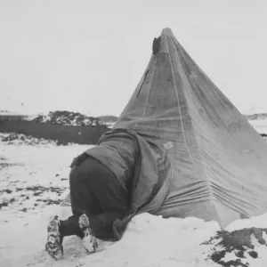 Dr Edward Wilson entering his tent at Cape Royds