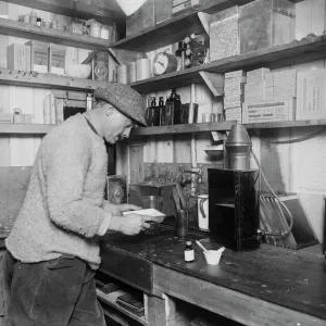 Herbert Ponting at work in darkroom. March 24th 1911