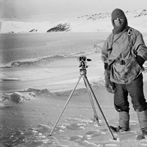 Lt Edward Evans and one of the sledging theodolites, (Barne Glacier in the background). October 1911