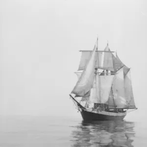 Penola at sea with sails set, reflections in the water