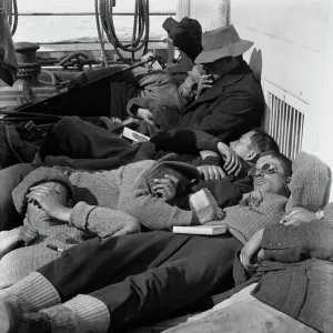 A warm day in the pack. Expedition members lie in the sun on the deck of the ship Terra Nova. December 28th 1910