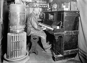 British Antarctic Expedition 1910-13 (Terra Nova) Collection: Cecil Meares at the pianola in the Winterquarters Hut. January 1912