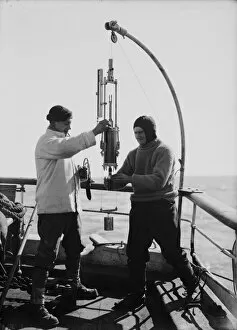 British Antarctic Expedition 1910-13 (Terra Nova) Gallery: Edward Nelson and Dennis Lillie taking sample from bottle. January 1st 1911