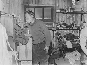 George Murray Levick Collection: George Murray Levick shaves by candlelight in the hut