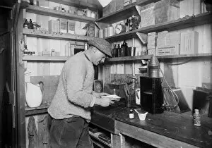 Herbert Ponting at work in darkroom. March 24th 1911