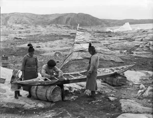 British Arctic Air Route Expedition 1930-31 Gallery: Inuit sewing skin on kayak