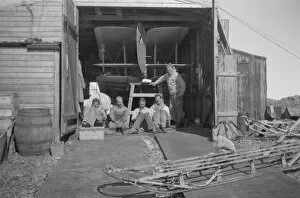British Graham Land Expedition 1934-37 Gallery: Party sitting in sun, beside the hangar door